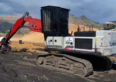Skemxist Solutions Equipment Power Clam Hydraulic Log Loader at OK Falls Log Sort Yard