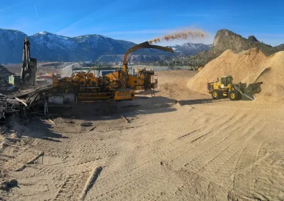 Skemxist Solutions Equipment Whole Log Chipper Excavator and Wheel Loader Making Chips at OK Falls Site
