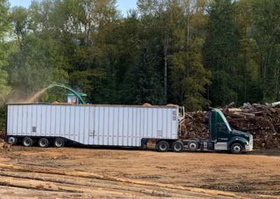 Skemxist Solutions Equipment Wood Residuals Truck Getting Loaded as Wood Waste Grinder is Grinding